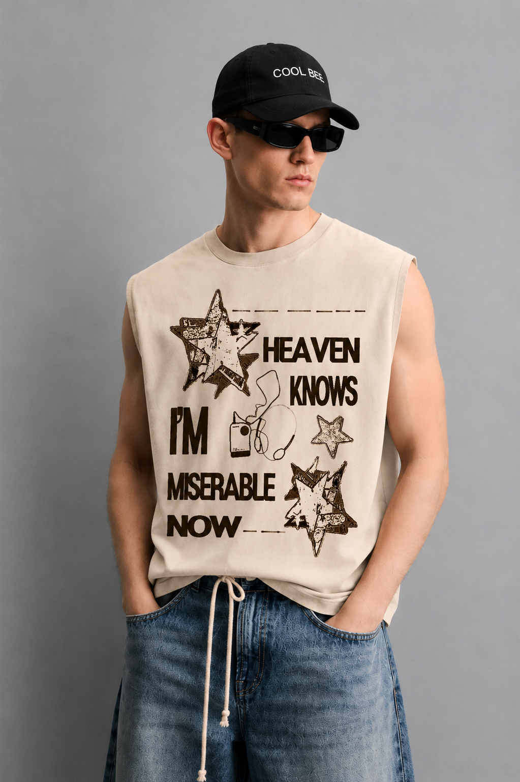 Beige tank top with a falling star illustration and melancholic poster-style lettering.