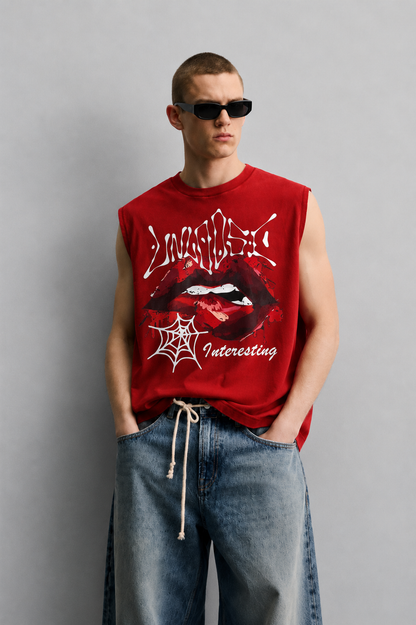 Red tank top with dripping graffiti-style 'Unholy' lettering, a close-up illustrated graphic of lips with a piercing detail, and a small spiderweb icon with script text.