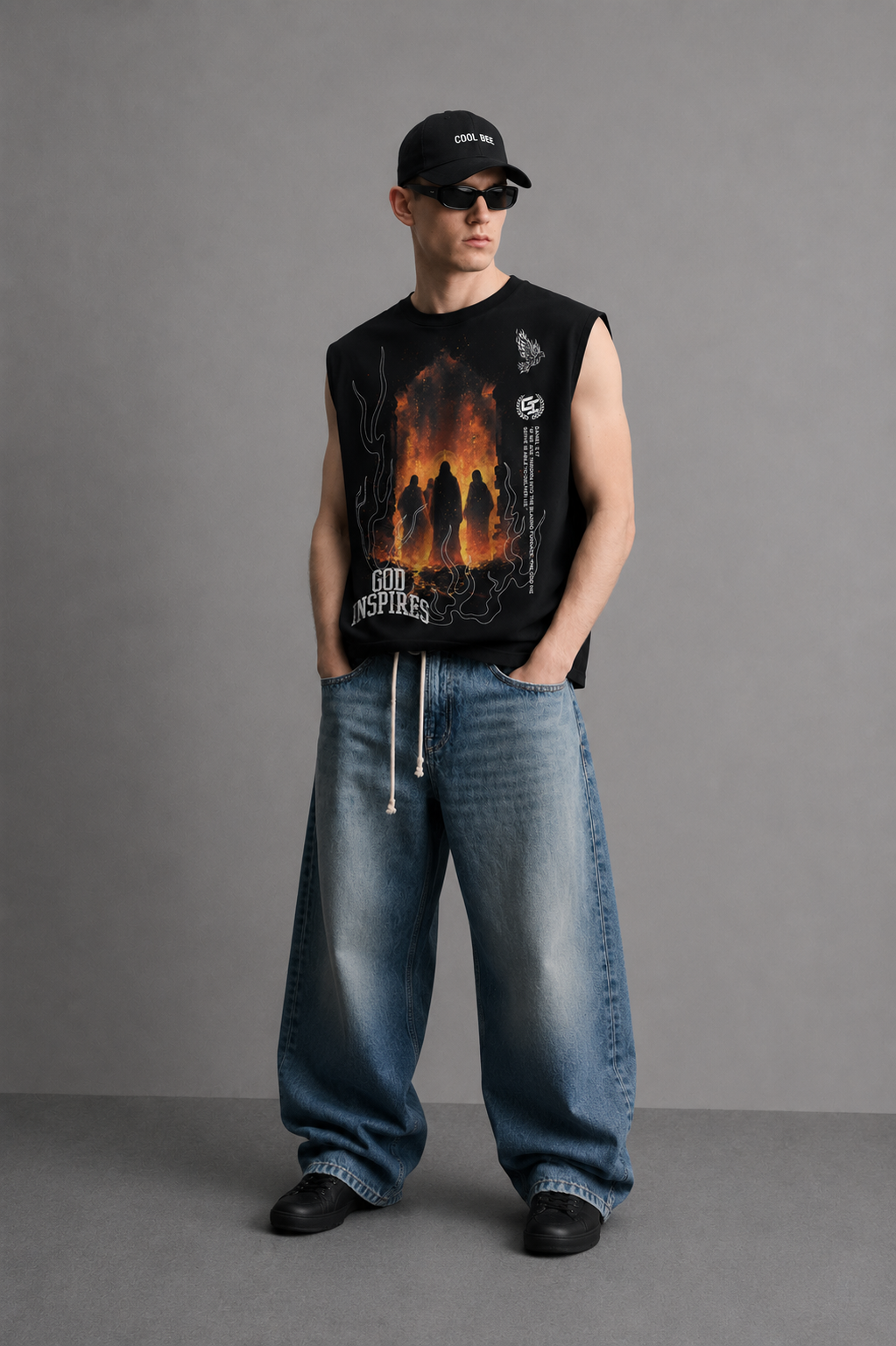 Black tank top with 'God Inspires' lettering, a photorealistic graphic of robed silhouettes before a blazing furnace, a phoenix line-art icon, and a vertical Bible verse from Daniel 3:17.