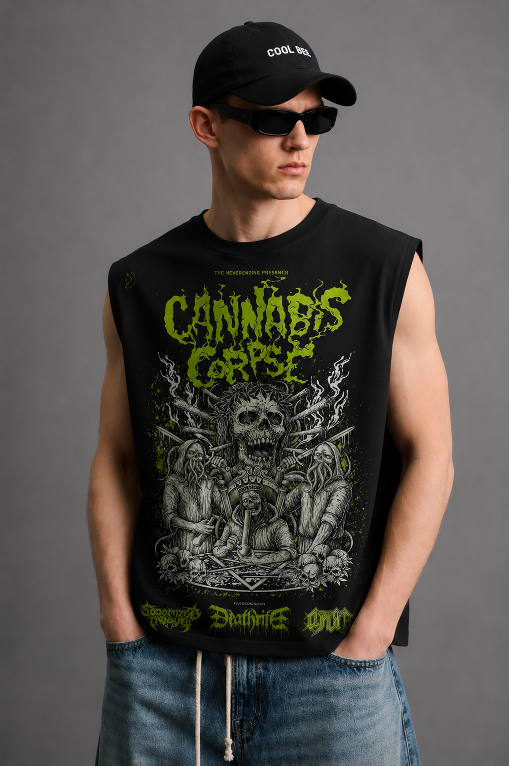 Black tank top with a horror-comic skeletal figure illustration surrounded by leafy plant motifs and bold neon-green lettering.