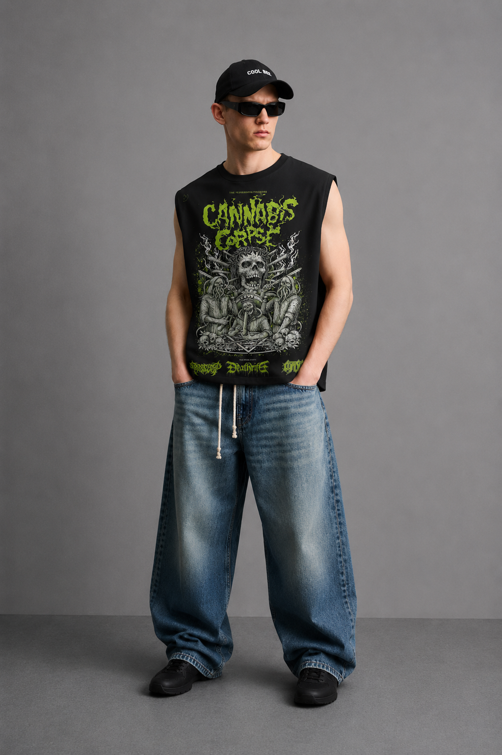 Black tank top with a horror-comic skeletal figure illustration surrounded by leafy plant motifs and bold neon-green lettering.