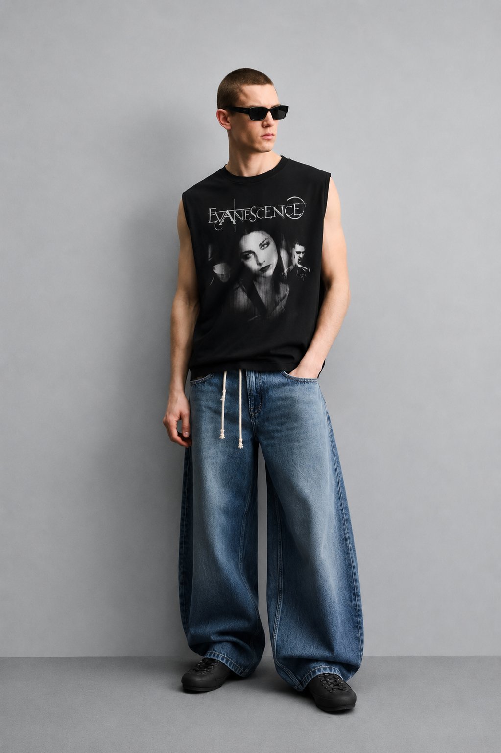 Black tank top with bold distressed band-style lettering above a black-and-white photo collage of three musicians.