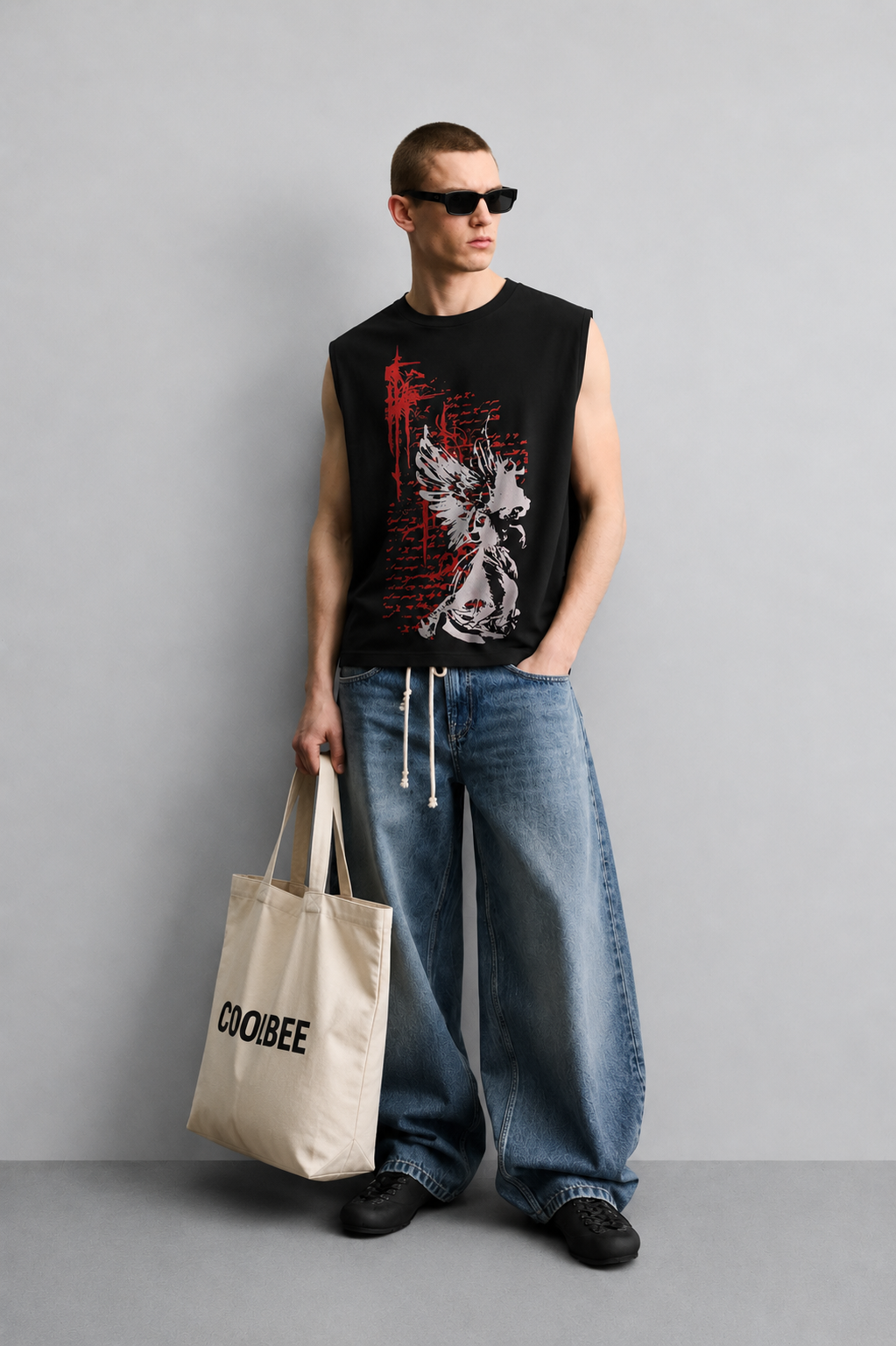 Black tank top with a winged angel-skeleton silhouette in white over a red graffiti-style scratch and script-text background.