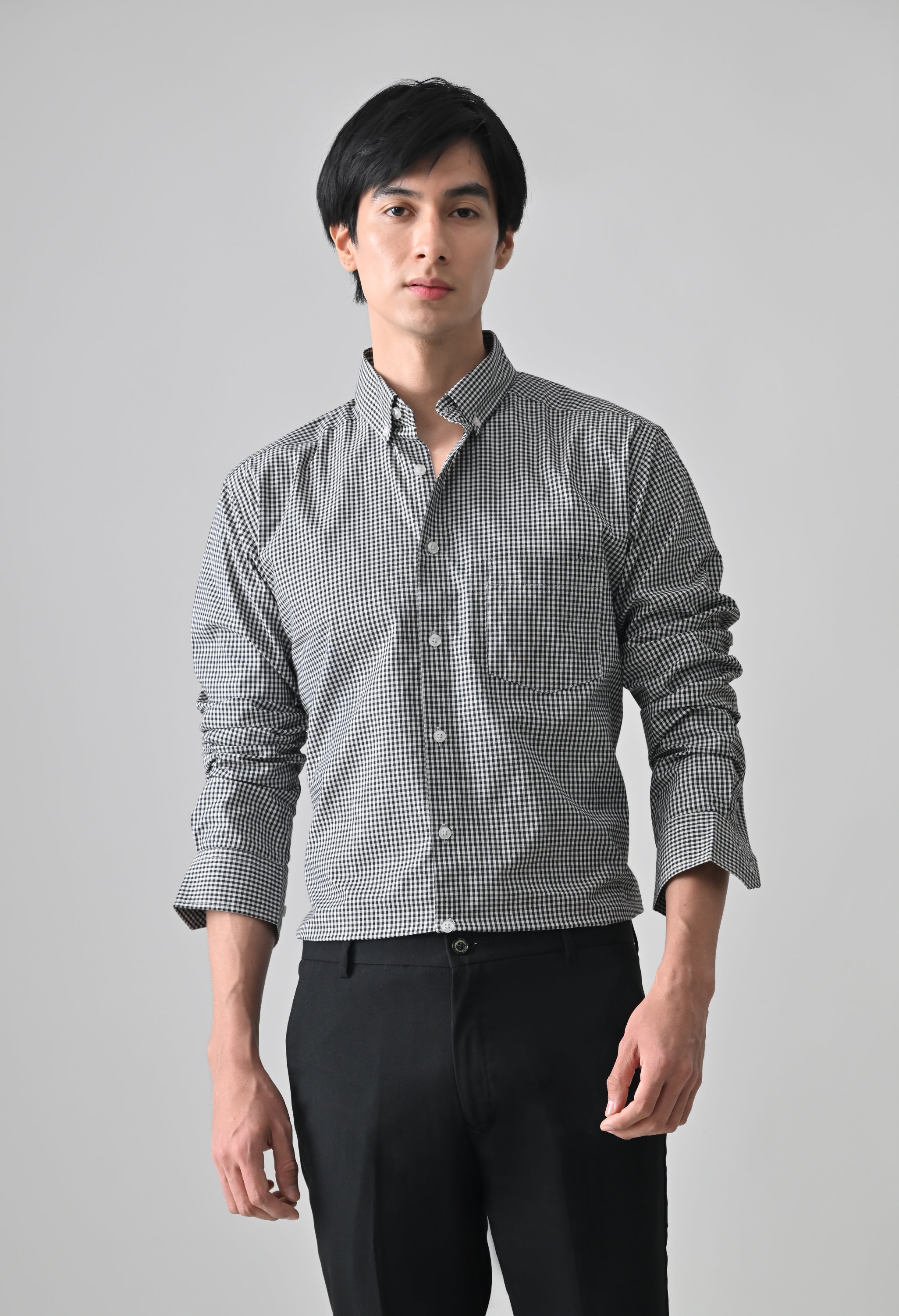 Man wearing a checkered shirt and dark pants on a gray background www.coolbeestore.com