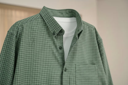 Green checkered shirt with a collar and buttons, brand logo visible.