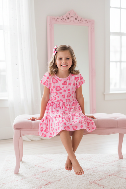 Coolbee Store – Girl on pastel bench wearing pink heart print tiered dress