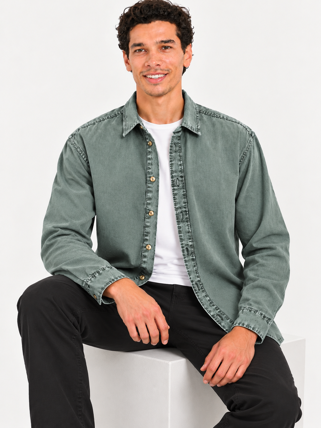Cool Bee Sage Heritage Washed Denim Shirt – model seated, sage green denim shirt layered over white tee